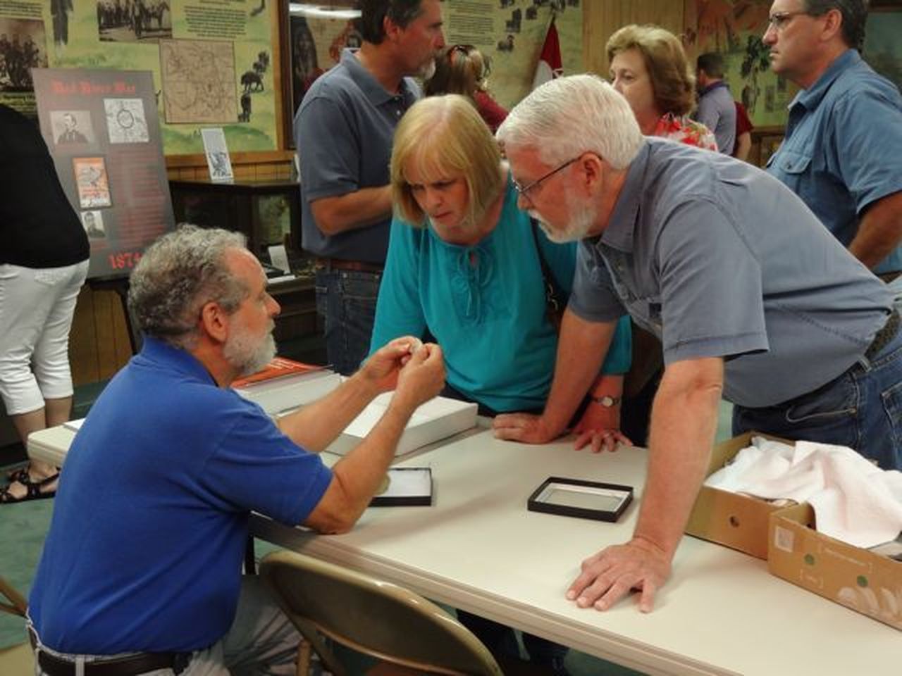 Archaeological expert Paul Katz examining visitor’s artifacts.